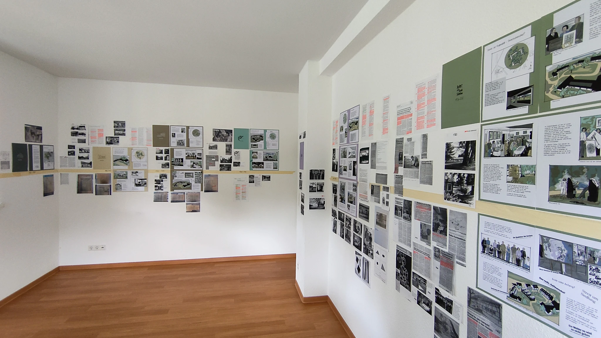 Foto der Wände im Projektbüro mit den neuen Buchseiten und Recherchematerial